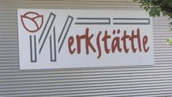 Schild "Werkstättle" mit stilisiertem Logo einer Tulpe.